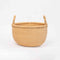 Handwoven round Bolga market basket with leather-wrapped handle, made in Ghana