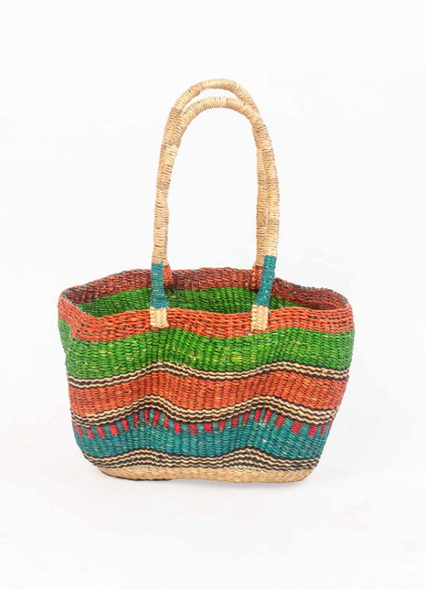 Multicolored woven basket with handles on a white background